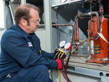 Technician servicing HVAC equipment