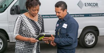 Two employees discussing items on a tablet